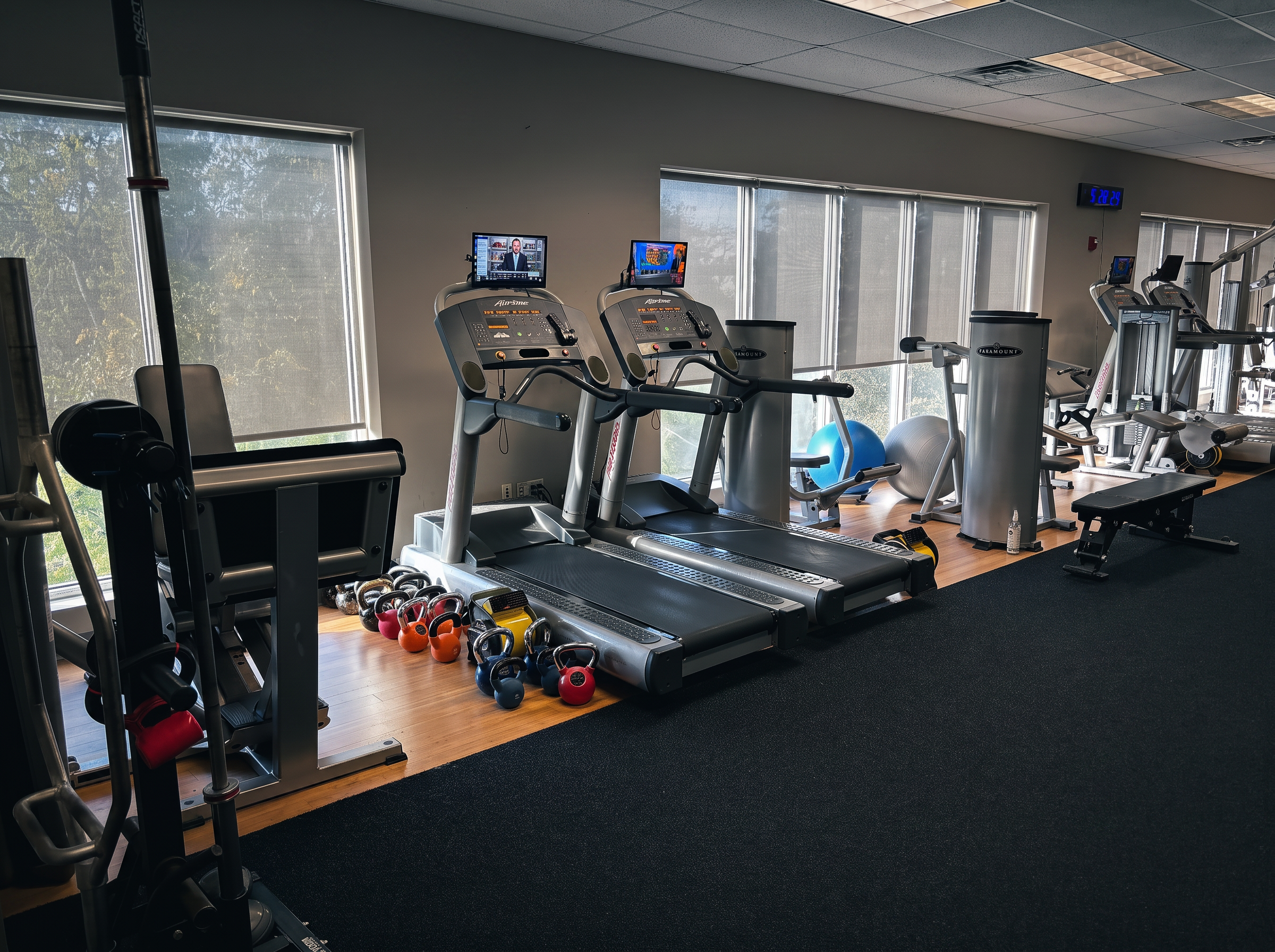 Cardio and conditioning area with treadmills and kettlebells at District Flex